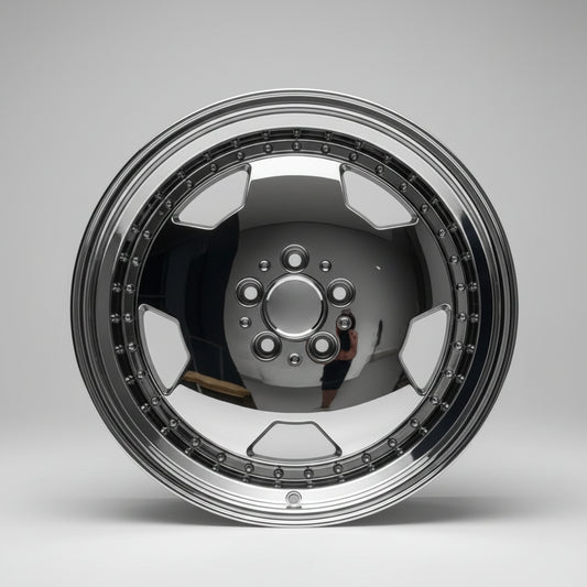 A polished chrome aftermarket car wheel rim with a multi-spoke design and decorative outer lip, photographed on a white surface against a white wall.