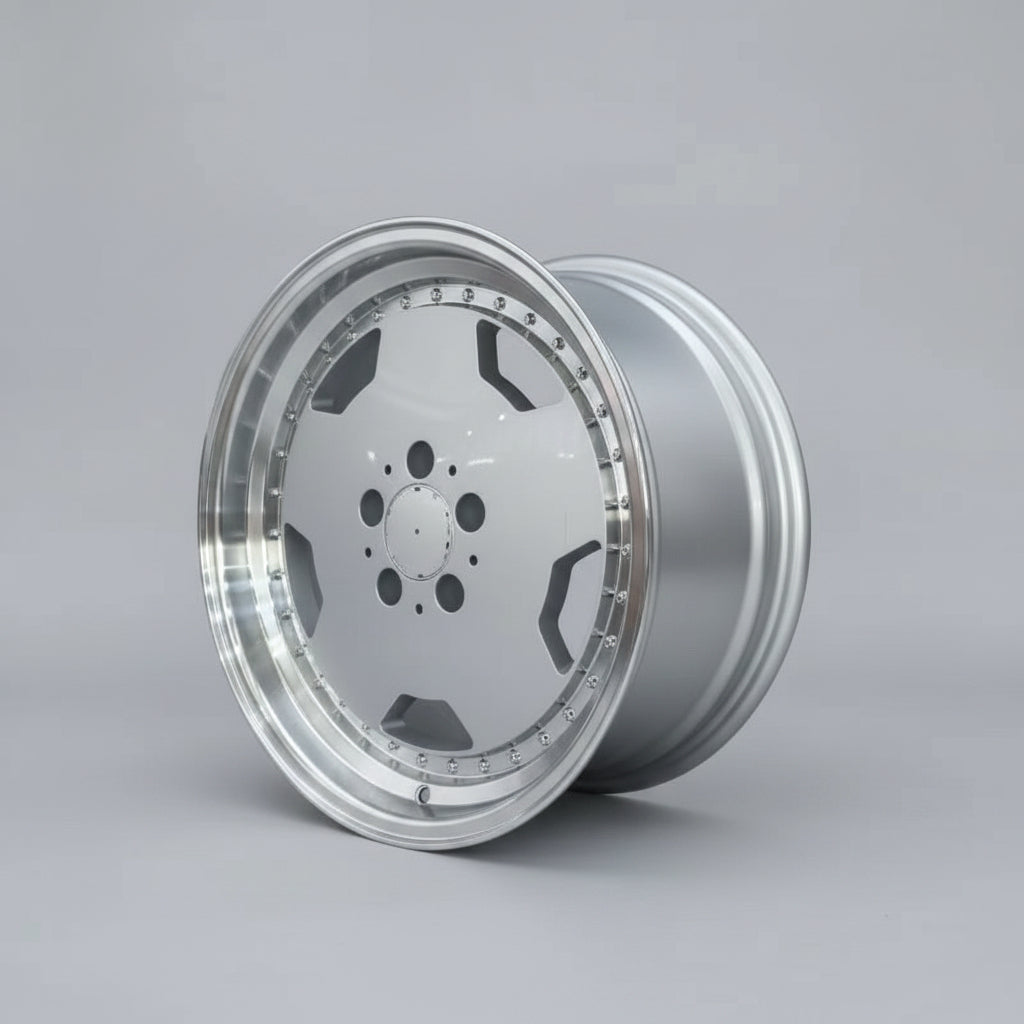 A silver multi-spoke alloy wheel rim displayed on a cardboard box in a warehouse setting.