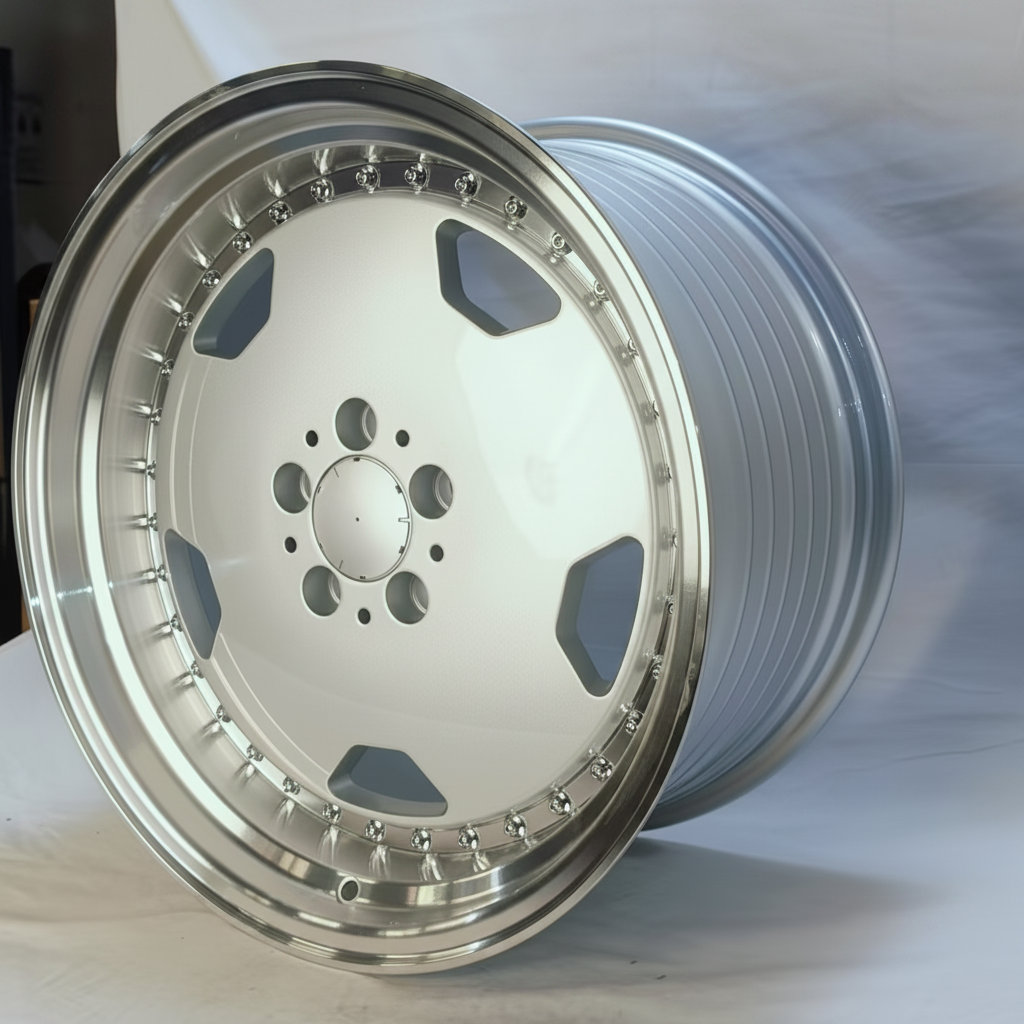 A polished silver multi-spoke alloy wheel rim shown at an angle, highlighting its machined metal finish and spoke details against a light gray background.